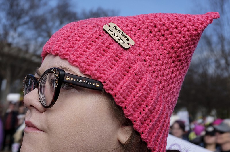 Staff photo by Doug Strickland / Jamie Griffith wears "Nevertheless she persisted" on her hat as she gathers with other demonstrators in Coolidge Park for the Chattanooga Women's March on Saturday, Jan. 20, 2018. Thousands of demonstrators gathered and marched here one year into the Trump administration to show solidarity with a national women's rights movement.
