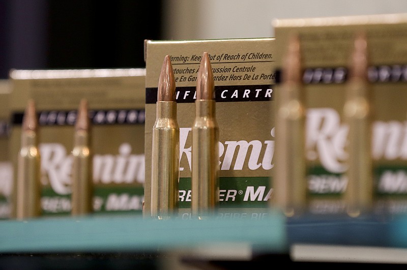 FILE - In this Jan. 15, 2013, file photo, Remington rifle cartridges are displayed at the 35th annual SHOT Show in Las Vegas. Remington, the gunmaker beset by falling sales and lawsuits tied to the Sandy Hook Elementary School massacre, said Monday, Feb. 12, 2018, that it has reached a financing deal that would allow it to continue operating as it files for Chapter 11 bankruptcy protection. (AP Photo/Julie Jacobson, File)