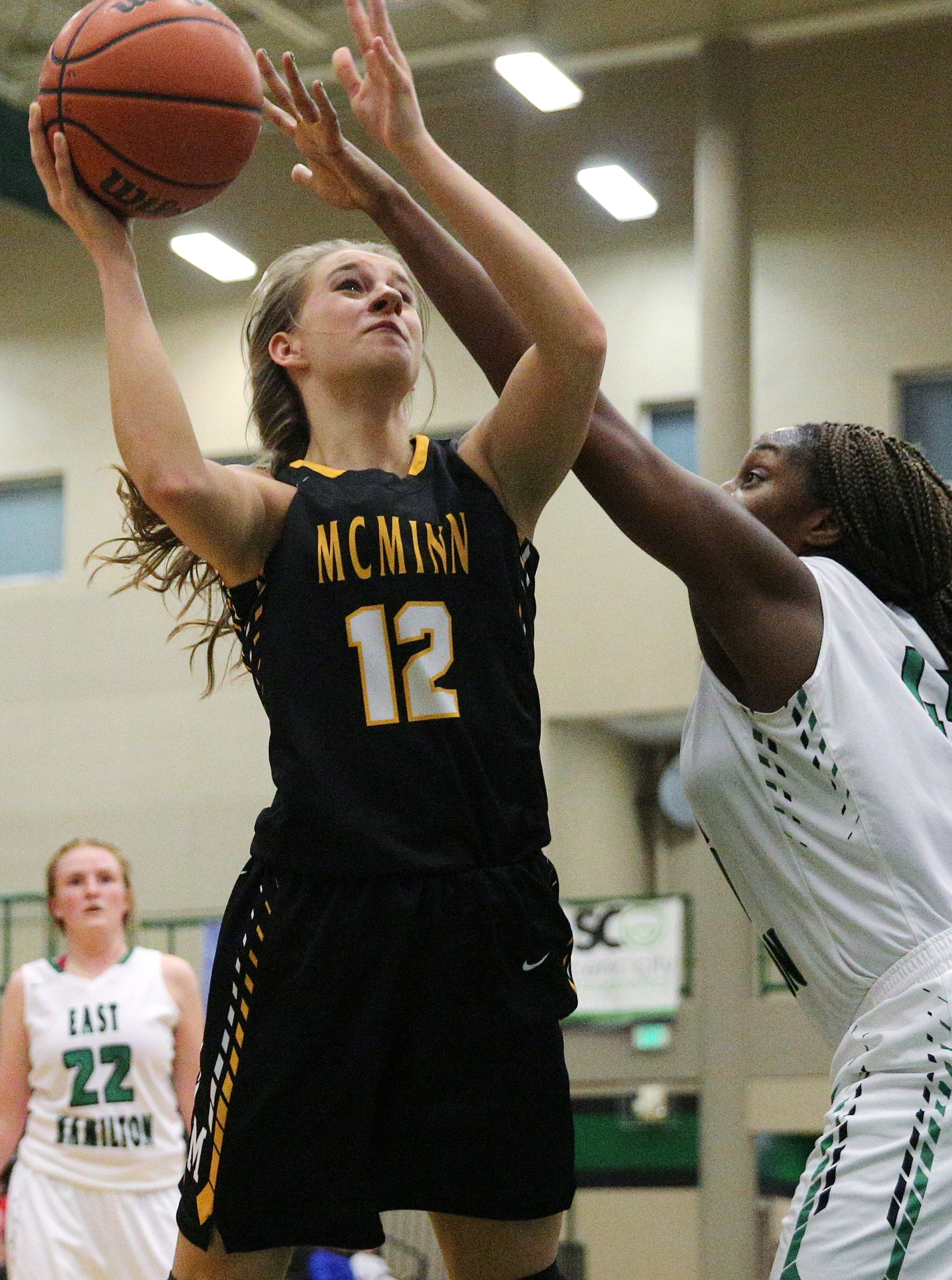 McMinn County's Kaitlynn Hennessee (12) puts up a shot while being guarded by East Hamilton's Eliziah LaBoo (45) during the East Hamilton vs. McMinn County girls basketball game Monday, Feb. 12, 2018 at East Hamilton Middle High School in Ooltewah, Tenn.