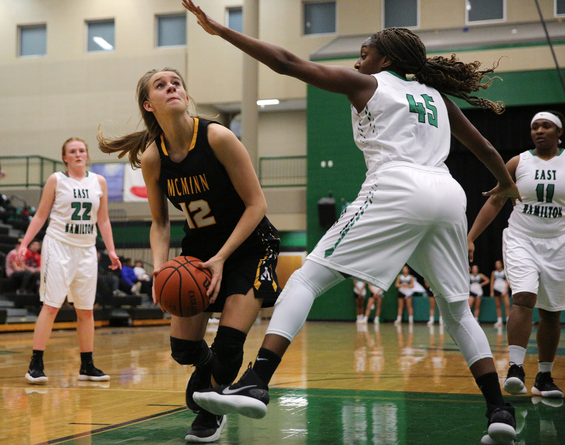 McMinn County's Kaitlynn Hennessee (12) puts up a shot while being guarded by East Hamilton's Eliziah LaBoo (45) during the East Hamilton vs. McMinn County girls basketball game Monday, Feb. 12, 2018 at East Hamilton Middle High School in Ooltewah, Tenn.
