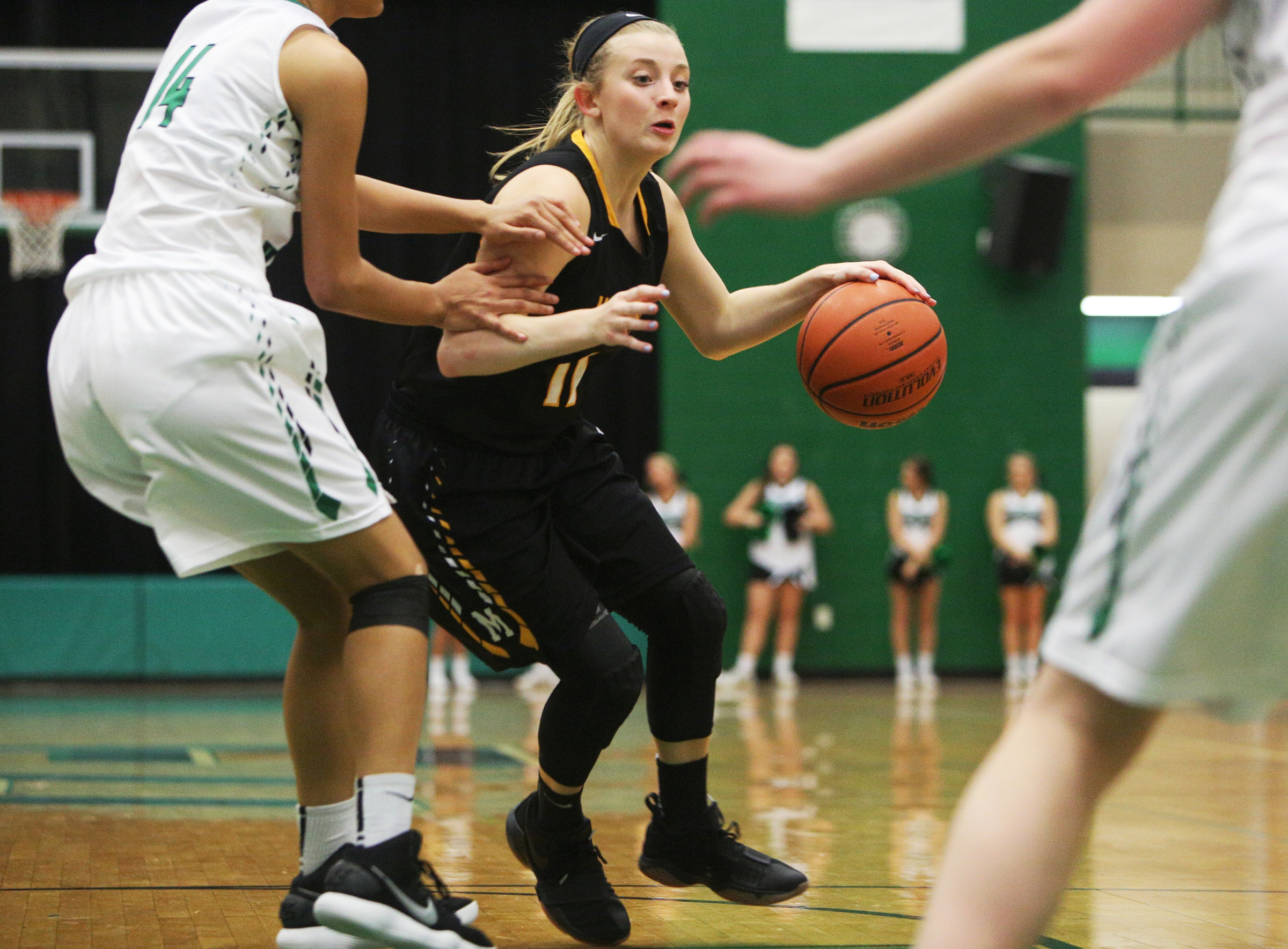 McMinn County's Hannah Burns (11) dribbles the ball while being guarded by East Hamilton's Madison Hayes (14) during the East Hamilton vs. McMinn County girls basketball game Monday, Feb. 12, 2018 at East Hamilton Middle High School in Ooltewah, Tenn.