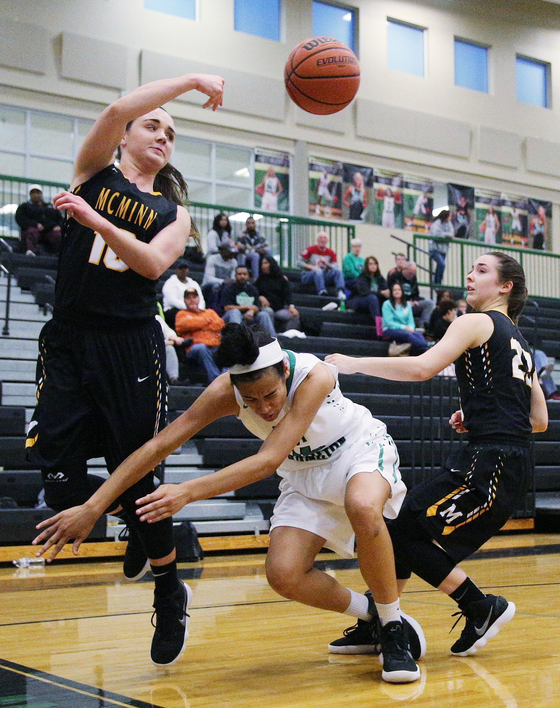 McMinn County's Emily Liner (10) tosses the ball back in play as East Hamilton's Madison Hayes (14) and McMinn County's Kaylen Hicks (23) go after the ball during the East Hamilton vs. McMinn County girls basketball game Monday, Feb. 12, 2018 at East Hamilton Middle High School in Ooltewah, Tenn.