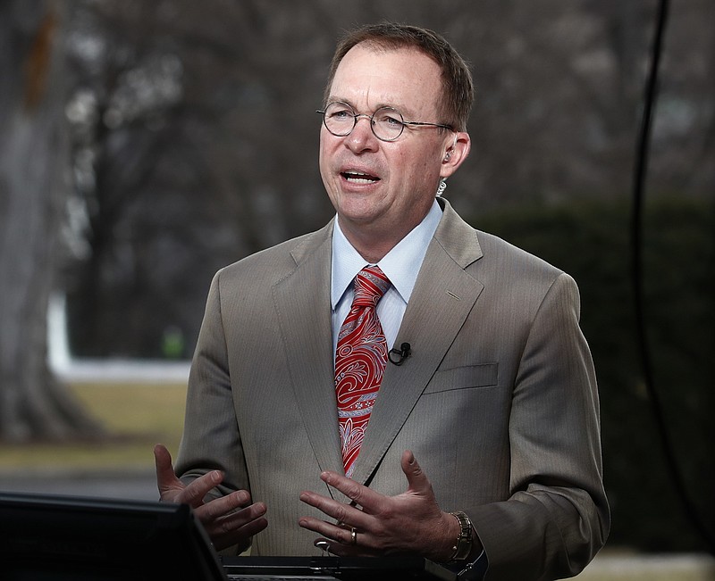 This Jan. 22, 2018, file photo shows Director of the Office of Management and Budget Mick Mulvaney talking during a television interview outside the White House in Washington. Mulvaney, the former tea party congressman who runs the White House budget office, said Sunday, Feb. 11, 2018, that Trump's new budget, if implemented, would tame the deficit over time, though unlike last year's submission, it wouldn't promise to balance the federal ledger eventually. (AP Photo/Carolyn Kaster, File)
