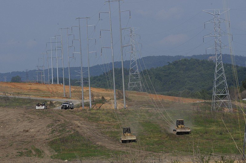 Staff file photo by Tim Barber/Chattanooga Times Free Press - May 23, 2011 - TVA transmission line crews use two dozers Monday to pull line onto nine new tower structures on the Widows Creek power network near the Widows Creek Coal plant in Stevenson, Ala., in 2011. The old towers were destroyed in a tornado outbreak.