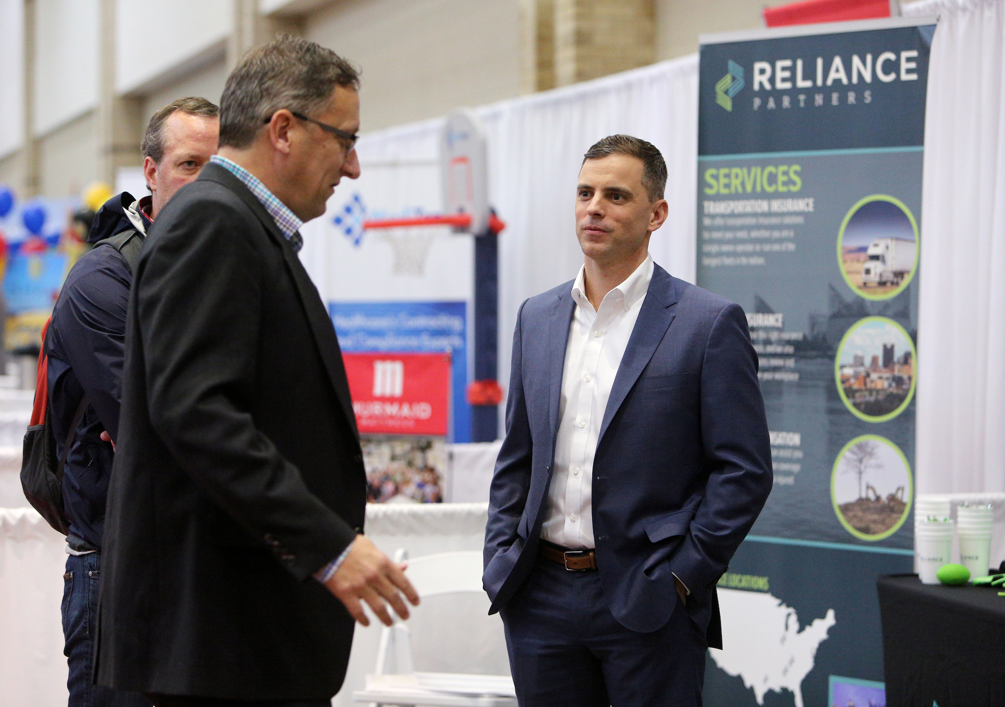 Richard Hans and Blake White speaks with Andrew Ladebauche, CEO of Reliance Partners, during the Small Business Awards Luncheon at the Chattanooga Convention Center on Tuesday, Feb. 13, 2018 in Chattanooga, Tenn. Reliance Partners won the Small Business Award for 45-200 employees category.