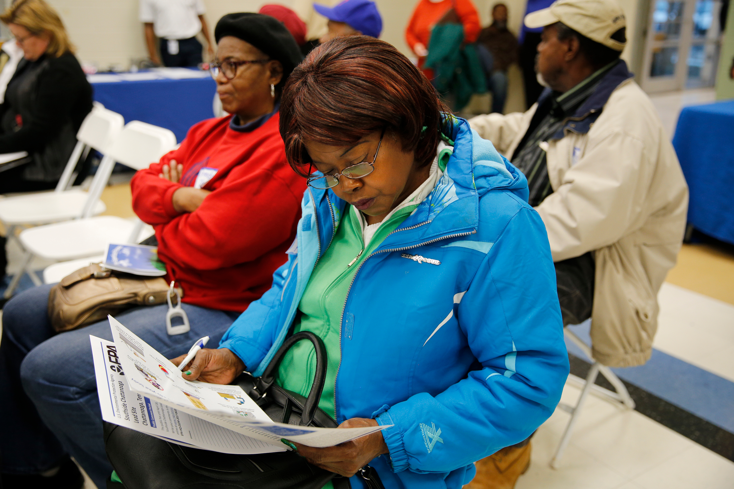 Blannie Gowdy reads a pamphlet during a public meeting held by the Environmental Protection Agency at South Chattanooga Recreation Center on Tuesday, Feb. 13, 2018, in Chattanooga, Tenn. The EPA held the meeting to address community concerns about lead pollution in the Southside Chattanooga Lead Site, which includes the Alton Park and Jefferson Heights neighborhoods.