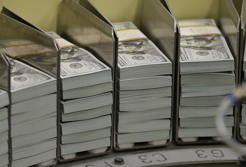 In this Sept. 24, 2013, file photo, just cut stacks of $100 bills make their way down the line at the Bureau of Engraving and Printing Western Currency Facility in Fort Worth, Texas. Tentative signs have emerged that prices could accelerate in coming months. Most economists expect inflation to edge up and end the year a few tenths of a percentage point above the Federal Reserve's target. But most foresee only minimal effect on the economy. (AP Photo/LM Otero, File)