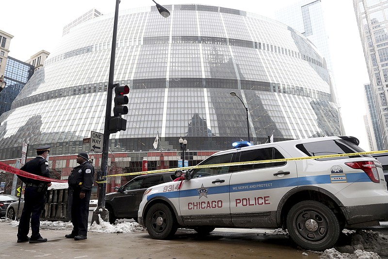 Police guard the crime scene after an off-duty Chicago police officer was shot at the James R. Thompson Center, in Chicago, Tuesday, Feb. 13, 2018. 