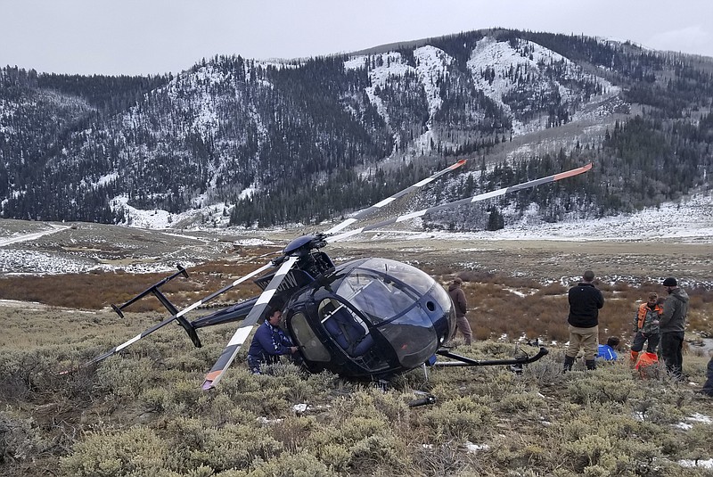 In this photo taken Monday, Feb. 12, 2018, and provided by the Wasatch County Sheriff's Office is a research helicopter that was brought down by a leaping elk in the mountains of eastern Utah. 