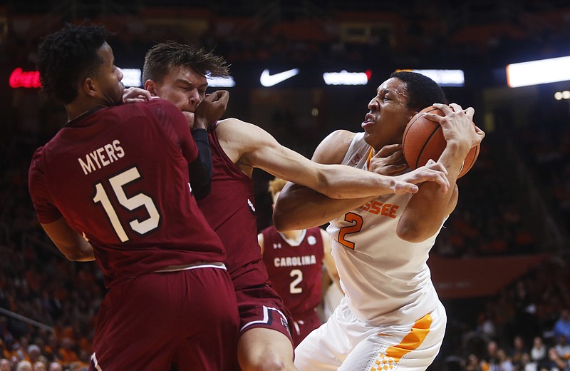 Tennessee forward Grant Williams (2) is defended by South Carolina guard Wesley Myers (15) and forward Maik Kotsar, center, during the first half of an NCAA college basketball game Tuesday, Feb. 13, 2018, in Knoxville, Tenn. (AP Photo/Crystal LoGiudice)