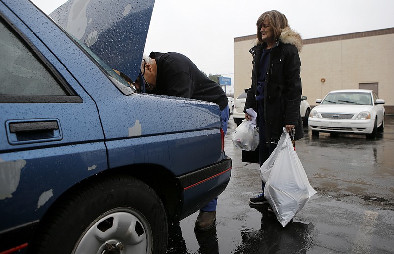 Deborah Campbell looks on as her husband Gary loads some belongings into their car at the Economy Inn on Wednesday, Feb. 14, 2018 in Chattanooga, Tenn. The Campbells, along with over 100 other residents, were forced out of their homes on short notice after authorities condemned the building as a public nuisance. The Campbells had been living at the Economy Inn for seven months.
