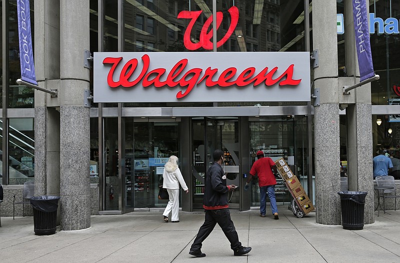 FILE - This June 4, 2014, file photo, shows a Walgreens retail store in Boston. Shares of AmerisourceBergen are soaring before the opening bell, Tuesday, Feb. 13, 2018,  on reports that Walgreens is pursuing a complete takeover of the huge drug distributor. The Wall Street Journal is reporting that Walgreens CEO Stefano Pessina reached out to AmerisourceBergen Corp. with the potential deal. Walgreens already owns about 26 percent of the company. (AP Photo/Charles Krupa, File)