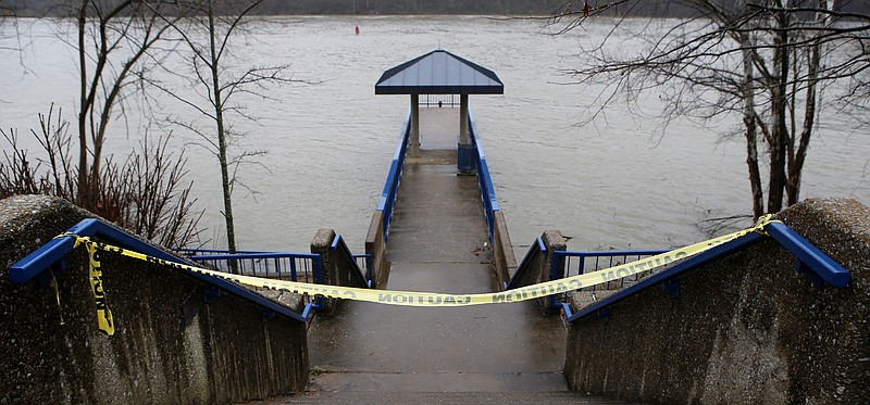 Caution tape marks off the stairs to the Krystal Pier at the Hubert Fry Center along the Tennessee Riverpark on Wednesday, Feb. 14, 2018 in Chattanooga, Tenn. According to the Hamilton County Parks and Recreation Department all of the piers and boat ramps were closed to the public due to high waters.