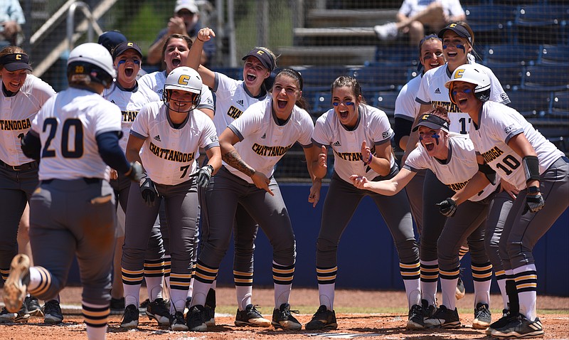 UTC softball players welcome Ashley Conner, left, to home plate after Jesslyn Stockard hit a home run during a game against Furman last spring at Frost Stadium.