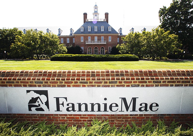FILE - This Aug. 8, 2011, file photo shows the Fannie Mae headquarters in Washington. Fannie Mae said Wednesday, Feb. 14, 2018, its net worth sank to a negative $3.7 billion after it had to "remeasure" its deferred tax assets to the tune of $9.9 billion as required by the Tax Cuts and Jobs Act, signed into law by President Donald Trump just before the end of the year. (AP Photo/Manuel Balce Ceneta, File)
