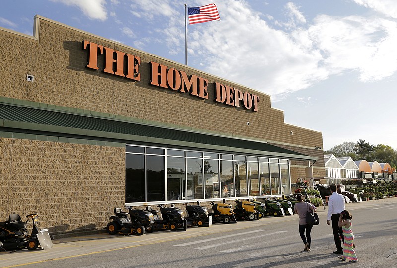 FILE - In this May 18, 2016, file photo, people approach an entrance to a Home Depot store in Bellingham, Mass. Lowe's and Home Depot plan on hiring thousands of workers to fill seasonal jobs as the spring and summer rush approaches. The Home Depot Inc., on Wednesday, Feb. 14, 2018, unveiled a new app that allows job-seekers to self-schedule an interview. (AP Photo/Steven Senne, File)