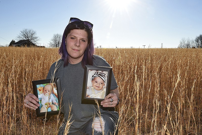 Sarah Sherbert poses for a photo in Anderson, S.C., on Monday, Feb. 5, 2018, holding photos of her children when they were infants. 