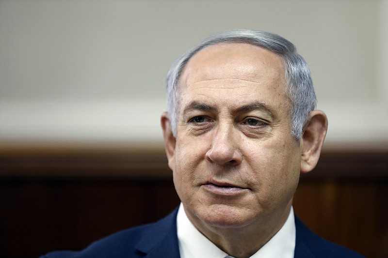 In this Sunday, Feb. 11, 2018, file photo, Israeli Prime Minister Benjamin Netanyahu chairs the weekly cabinet meeting at the Prime Minister's office in Jerusalem. Israeli media reports Tuesday, Feb. 13, 2018 say police recommending Netanyahu indictment on corruption charges, including bribery. (Ronen Zvulun, Pool via AP, File)