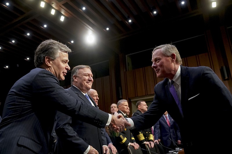 Chairman Richard Burr, R-N.C., right, greets FBI Director Christopher Wray, left, before a Senate Select Committee on Intelligence hearing on worldwide threats, Tuesday, Feb. 13, 2018, in Washington. Also pictured is CIA Director Mike Pompeo, second from left. (AP Photo/Andrew Harnik)