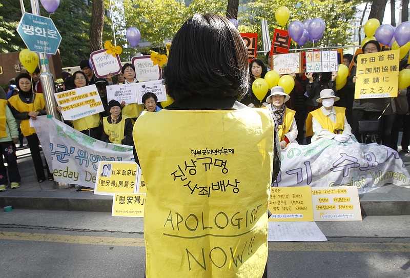 In this Oct. 19, 2011 file photo, former South Korean comfort women who were forced to serve for the Japanese Army as sexual slaves during World War II, stage a rally to demand an official apology and compensation from the Japanese government in front of the Japanese Embassy in Seoul, South Korea. The fierce grudges over historical persecution and a thousand perceived national and cultural slights cannot be untwined from the sports for many Koreans, and these swirling emotions will be front and center Wednesday, Feb. 14, 2018, when a combined team of North and South Koreans plays regional power Japan in women's hockey. (AP Photo/Ahn Young-joon, File)