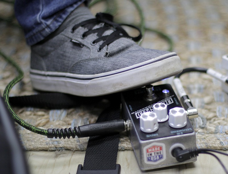 Alex Bell, 14, steps on a distortion pedal while playing Metallica's "One" during a lesson with Songbirds Foundation Director Reed Caldwell at the Siskin Children's Institute on Wednesday, Jan. 31, 2018 in Chattanooga, Tenn.
