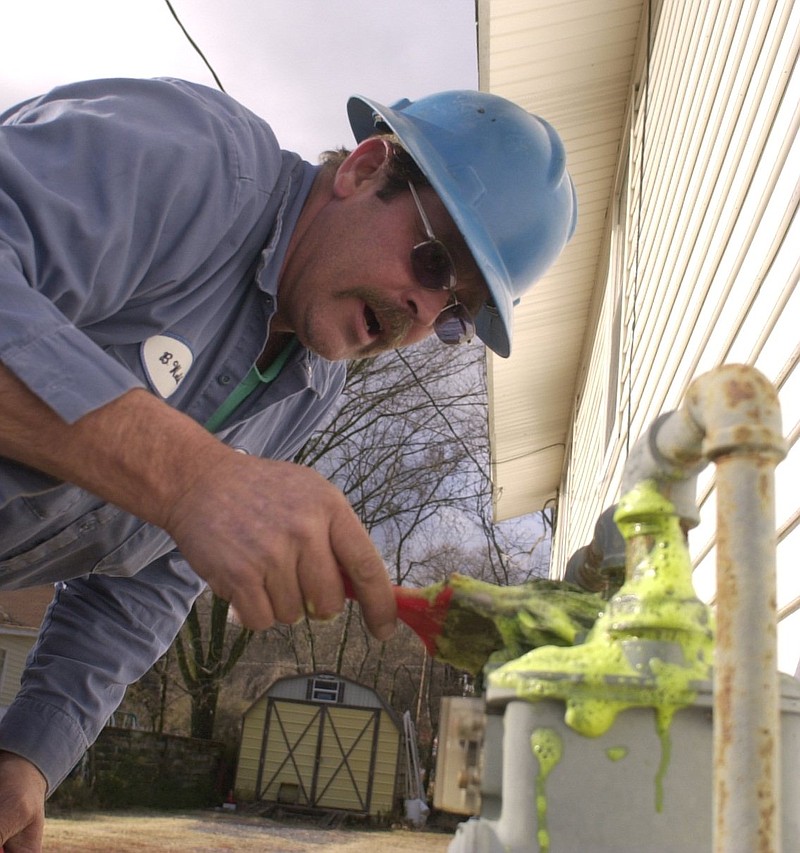 Chattanooga Gas distribution operator Billy Welch soaps a residential gas meter on Lyndon Avenue in Red Bank to check for leaks Friday afternoon. "We were fixing a corrosion leak in a 2 inch main," the crew leader said. "This house was off line for approximately 2 hours." 