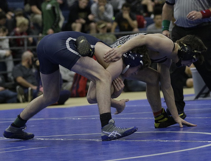 McCallie's Alex Whitworth, left, tries to maintain his grasp on Scottsboro's John McAlphin during the championship finals of the McCallie Invitational in December.
