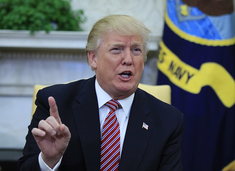 President Donald Trump speaks about domestic violence during a working session regarding the opportunity zones provided by tax reform in the Oval Office of the White House, Wednesday, Feb. 14, 2018, in Washington. Trump responded to a question and said, "I am totally opposed to domestic violence of any kind everyone knows that and it almost wouldn't even have to be said." (AP Photo/Manuel Balce Ceneta)