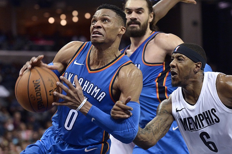 Oklahoma City Thunder guard Russell Westbrook (0) is fouled by Memphis Grizzlies guard Mario Chalmers (6) as he drives to the basket in the first half of an NBA basketball game Wednesday, Feb. 14, 2018, in Memphis, Tenn. (AP Photo/Brandon Dill)