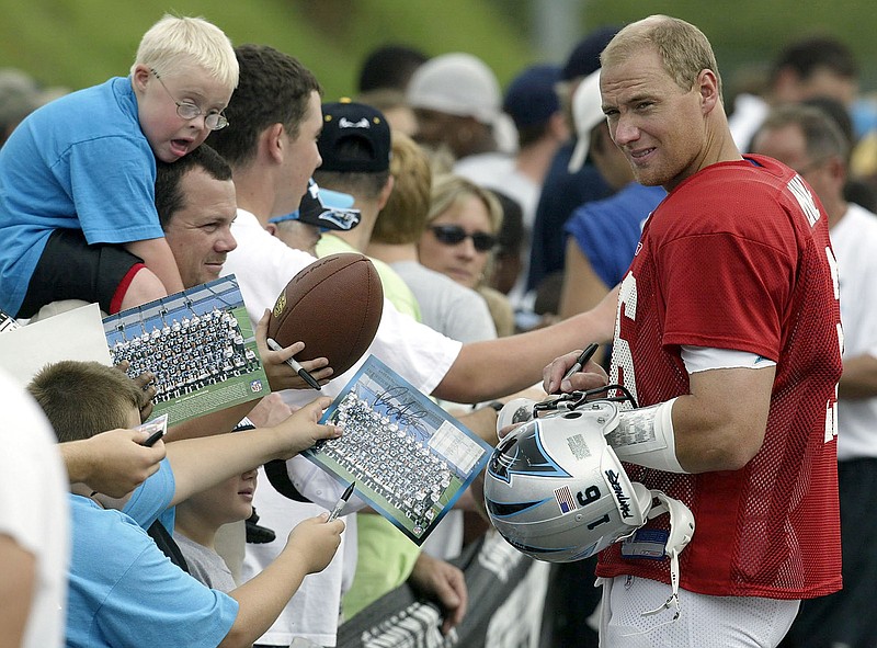 Chris Weinke, right, signs autographs during Carolina Panthers training camp in 2003. 