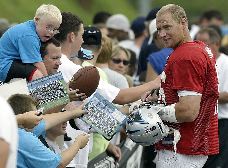Chris Weinke, right, signs autographs during Carolina Panthers training camp in 2003. Weinke, who played at Florida State University before going on to the NFL, spent the past two seasons as quarterbacks coach for the Rams.