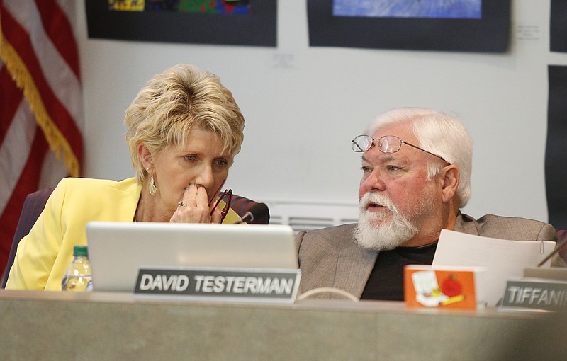 Board members Rhonda Thurman, left, and David Testerman whisper to one another during discussion of a state partnership zone for low performing schools during a meeting of the Hamilton County Board of Education on Thursday, Sept. 21, 2017, in Chattanooga, Tenn.