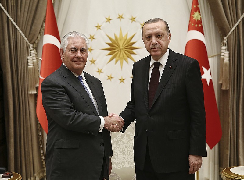Turkey's President Recep Tayyip Erdogan, right, and US Secretary of State Rex Tillerson shake hands before their talks at the presidential palace in Ankara, Turkey, Thursday, Feb. 15, 2018. Tillerson started a two-day trip to Turkey amid growing tensions between the two NATO allies.(Pool Photo via AP)