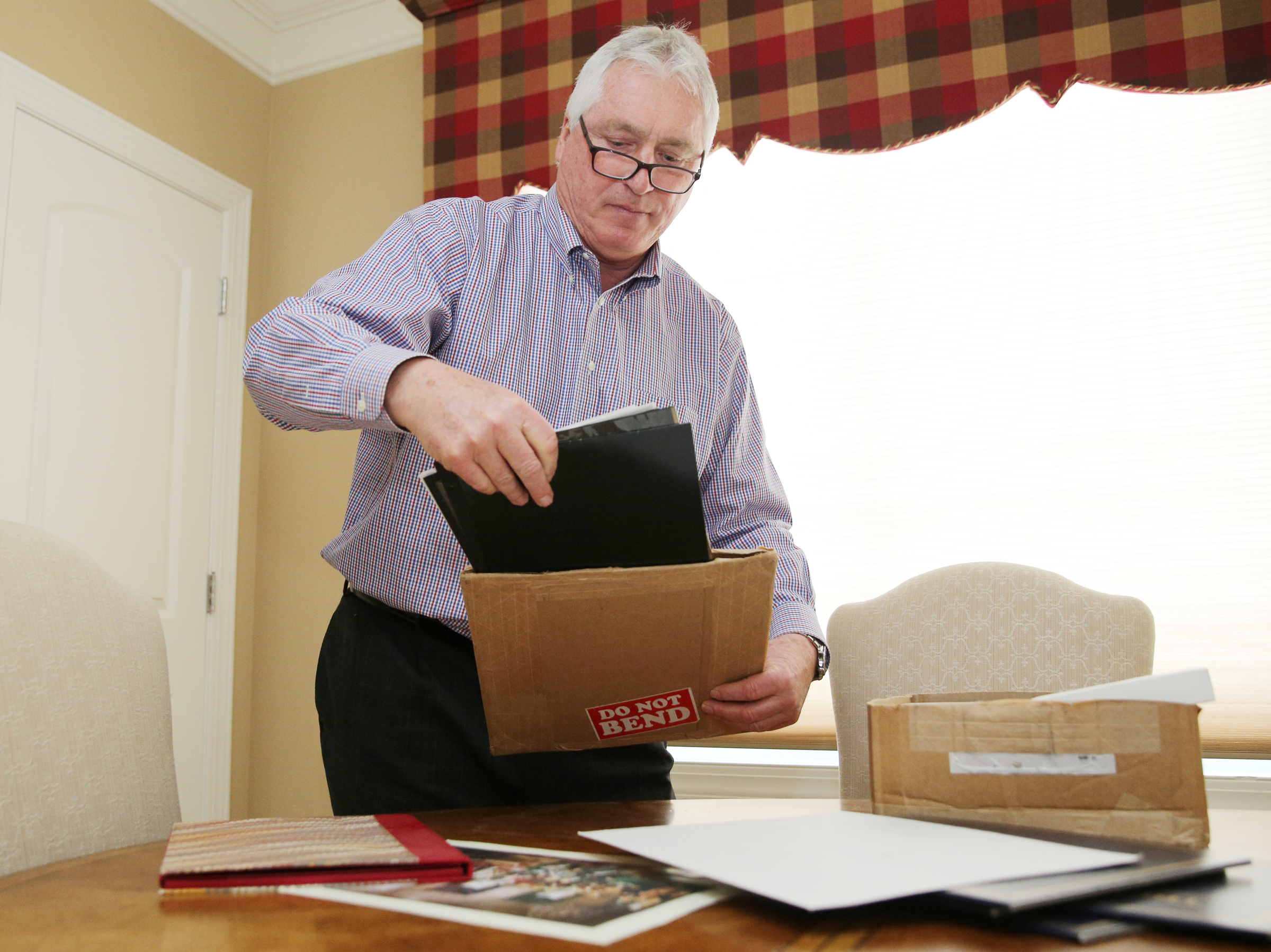 George Nelson looks through documents at his home Wednesday, Feb. 7, 2018 in Chattanooga, Tenn. Nelson is a collector of documents and books signed by political and other well-known figures.