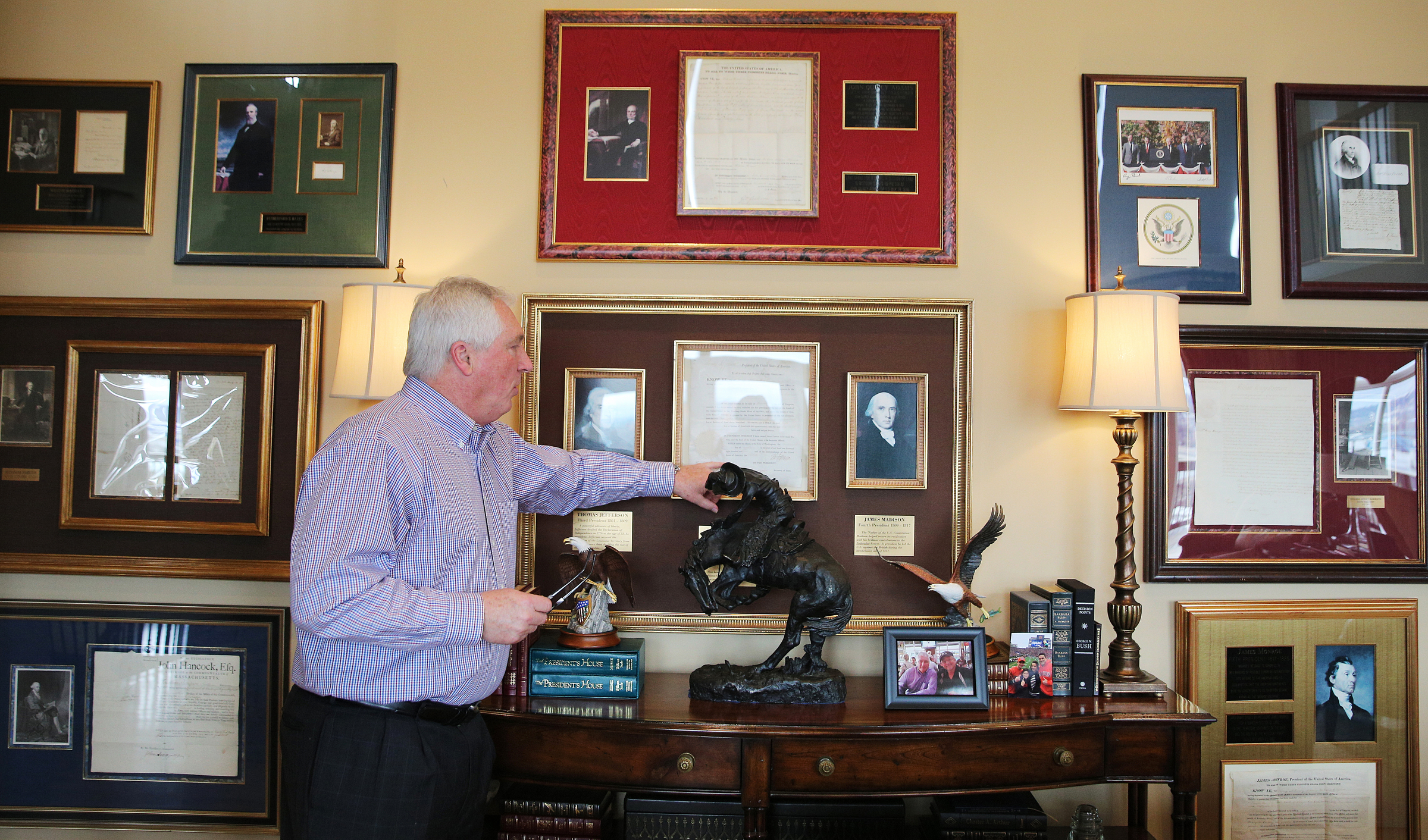 George Nelson talks about several documents he has on display at his home Wednesday, Feb. 7, 2018 in Chattanooga, Tenn. Nelson has documents signed by political figures such as George Washington and Thomas Jefferson displayed on his wall as well as more recent figures including Ronald Reagan and Jimmy Carter.
