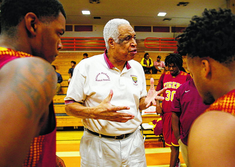 Longtime Howard boys' basketball coach Walter McGary talks with his team before Friday's district tournament quarterfinal against East Ridge. Howard won 55-50.