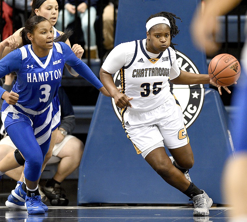 UTC's Aryanna Gilbert (35) heads upcourt with a defensive rebound as Hampton's Allina Starr (3) gives chase.  The Hampton Pirates visited the Chattanooga Mocs in NCAA women's basketball action at McKenzie Arena on December 28, 2017.  