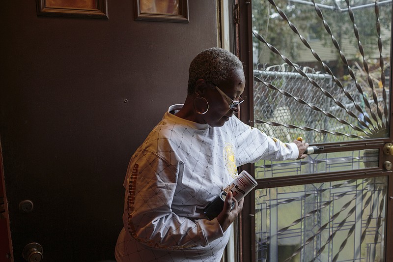 
              This Nov. 13, 2017, photo provided by Reveal, Adrienne Stokes, a longtime resident of Philadelphia’s historically black Point Breeze neighborhood, stands inside her home. In 2015, Stokes was denied a home improvement loan at her local bank, Firstrust Savings Bank. (Sarah Blesener/Reveal via AP)
            