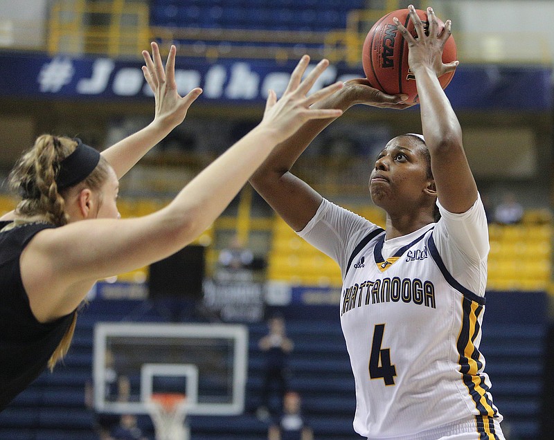 University of Tennessee at Chattanooga's Arianne Whitaker (4) puts up a shot Saturday, Feb. 17, 2018 during the UTC vs. Wofford women's basketball game at McKenzie Arena in Chattanooga, Tenn. 