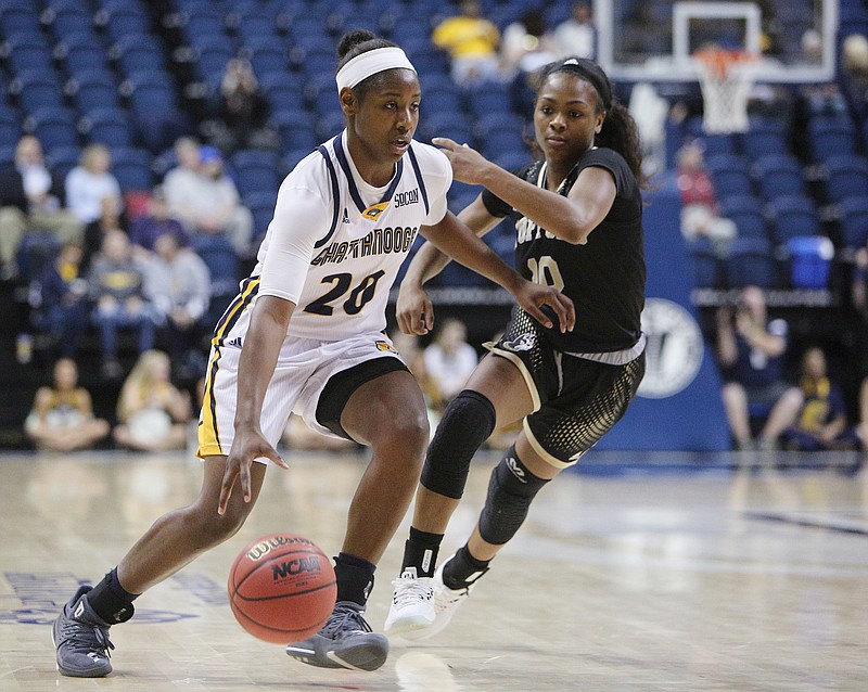 University of Tennessee at Chattanooga's Keiana Gilbert (20) dribbles the ball downcourt while guarded by Wofford's Cairo Booker (10) Saturday, Feb. 17, 2018 during the UTC vs. Wofford women's basketball game at McKenzie Arena in Chattanooga, Tenn. 