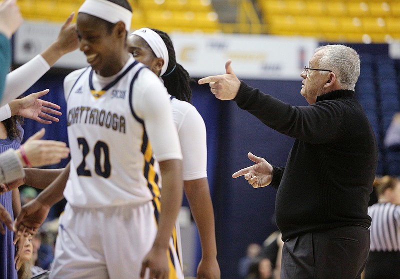 University of Tennessee at Chattanooga head basketball coach Jim Foster encourages fans to cheer for his team as a few girls come off the court near the end of the game Saturday, Feb. 17, 2018 during the UTC vs. Wofford women's basketball game at McKenzie Arena in Chattanooga, Tenn. 