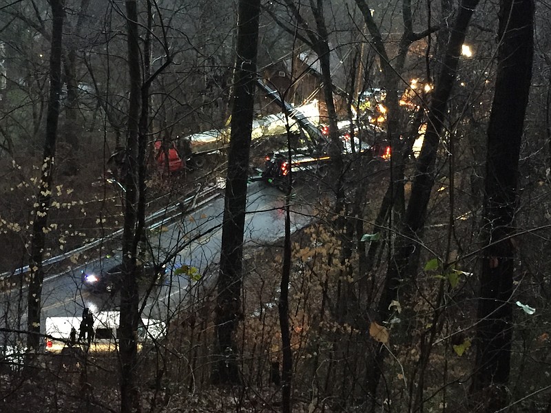 Reader photo: An overturned 18-wheeler can be seen from near reader John Sullivan's property in Chattanooga. One person died and two others were injured in the wreck. Sullivan said that rain, power lines, a steep terrain, nightfall and a structurally compromised trailer are slowing the cleanup process.