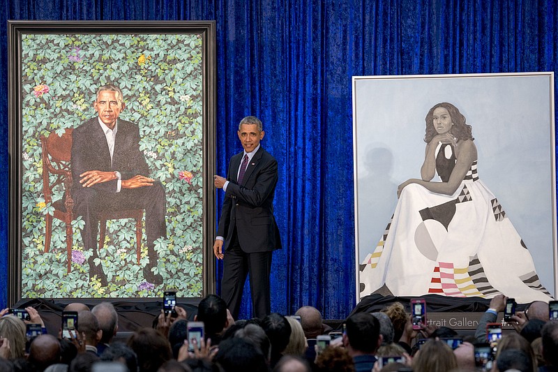 Former President Barack Obama, center, stands on stage during the unveiling of the Obamas' official portraits at the Smithsonian's National Portrait Gallery, last week in Washington.