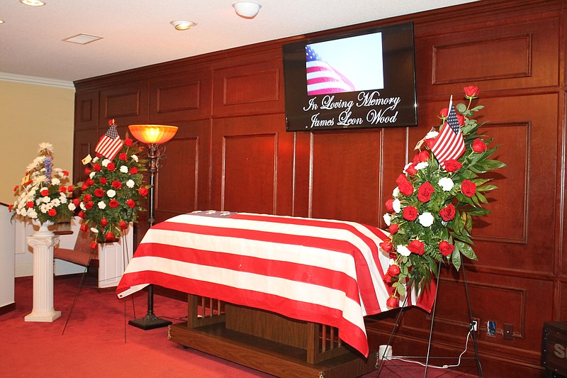 The body of U.S. Army National Guard veteran James Wood lies under the American flag Friday at his funeral service, where more than 300 people showed up after Wood's mother sent out a plea for people to attend because she was unable to do so. (Photo courtesy Philip Lorenz/Winchester Herald Chronicle)