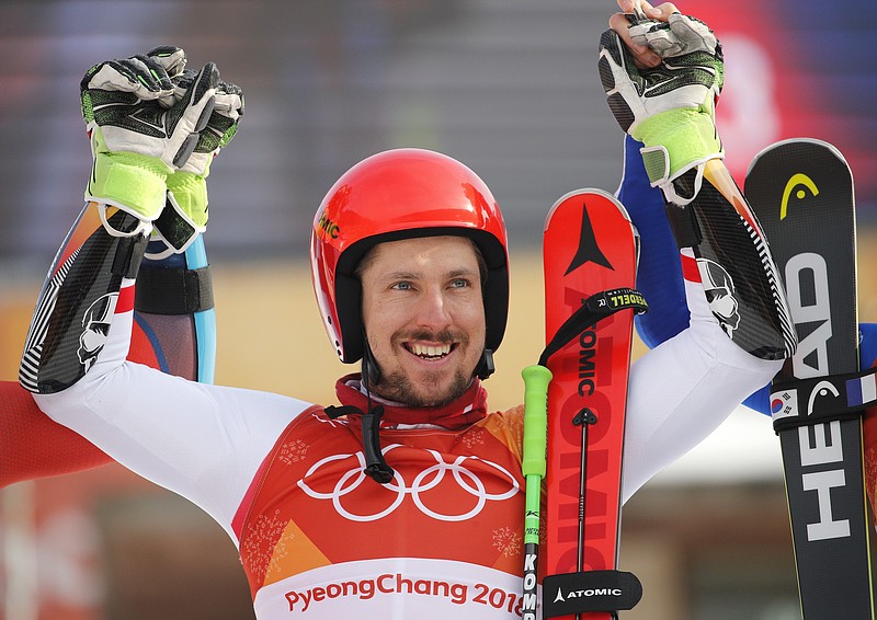 Austria's Marcel Hirscher who took the gold celebrates during the flower ceremony for the men's giant slalom at the 2018 Winter Olympics in Pyeongchang, South Korea, Sunday, Feb. 18, 2018. (AP Photo/Christophe Ena)