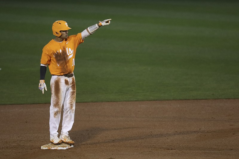 Tennessee catcher Benito Santiago motions toward the Tennessee dugout after reaching base in Tennessee's 2018 season opener against Maryland at Lindsey Nelson Stadium.