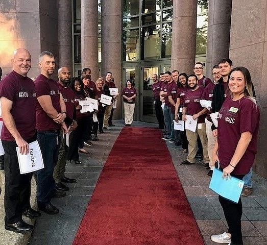 EPB employees participating in Big Brothers Big Sisters of Greater Chattanooga's Beyond School Walls workplace mentoring program roll out the red carpet for their sixth-grade mentees from East Lake Academy. (Contributed photo)
