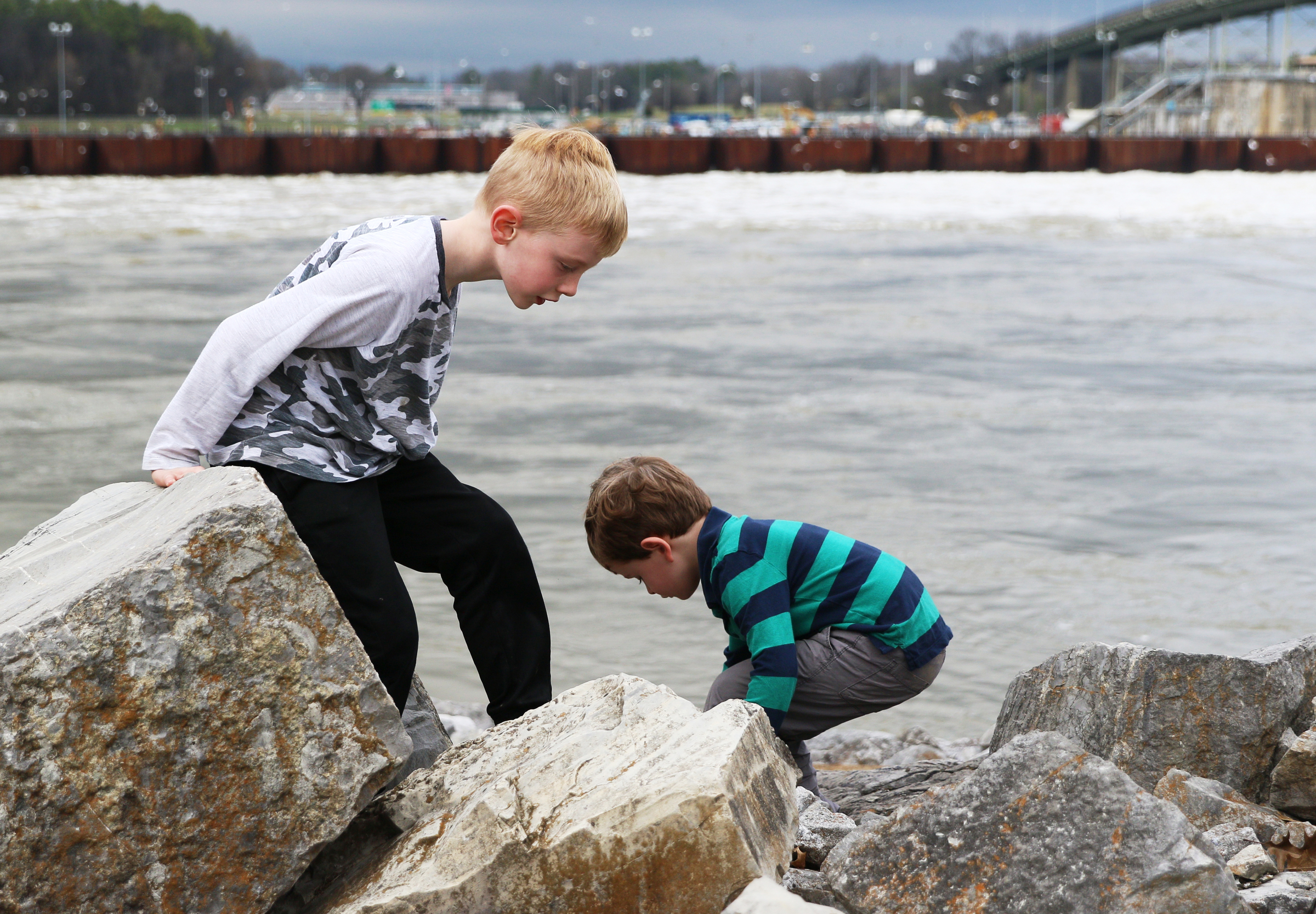 Jack Sokohl, 6, and Ben Sokohl, 4, climb on rocks Monday, Feb. 19, 2018 along the Chattanooga Riverwalk in Chattanooga, Tenn. The two were visiting the park with their grandparents Monday, exploring the rocks and geology in the area.