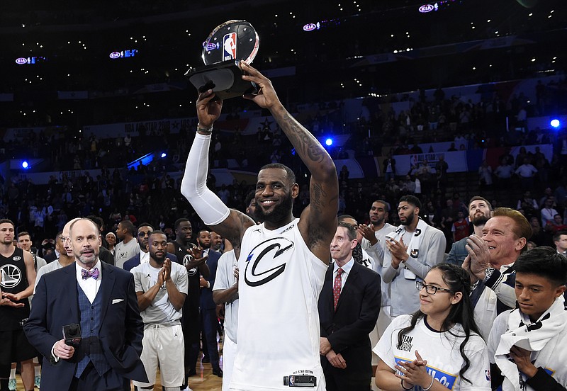 Team LeBron's LeBron James, of the Cleveland Cavaliers, holds the MVP trophy after his team defeated Team Stephen at the NBA All-Star basketball game, Sunday, Feb. 18, 2018, in Los Angeles. Team LeBron won 148-145. (AP Photo/Chris Pizzello)