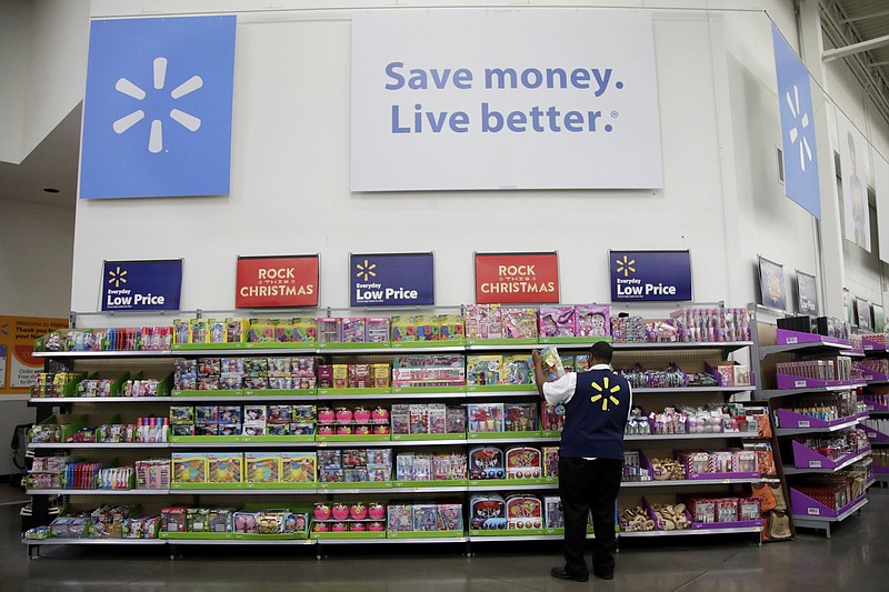 FILE- In this Nov. 9, 2017, file photo, Walmart employee Kenneth White scans items while conducting an exercise during a Walmart Academy class session at the store in North Bergen, N.J. Walmart reports financial results Tuesday, Feb. 20, 2018. (AP Photo/Julio Cortez, File)